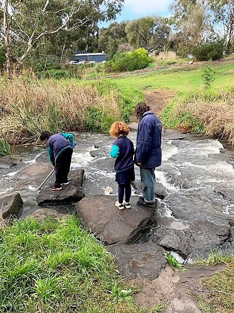 Kids testing water at creek